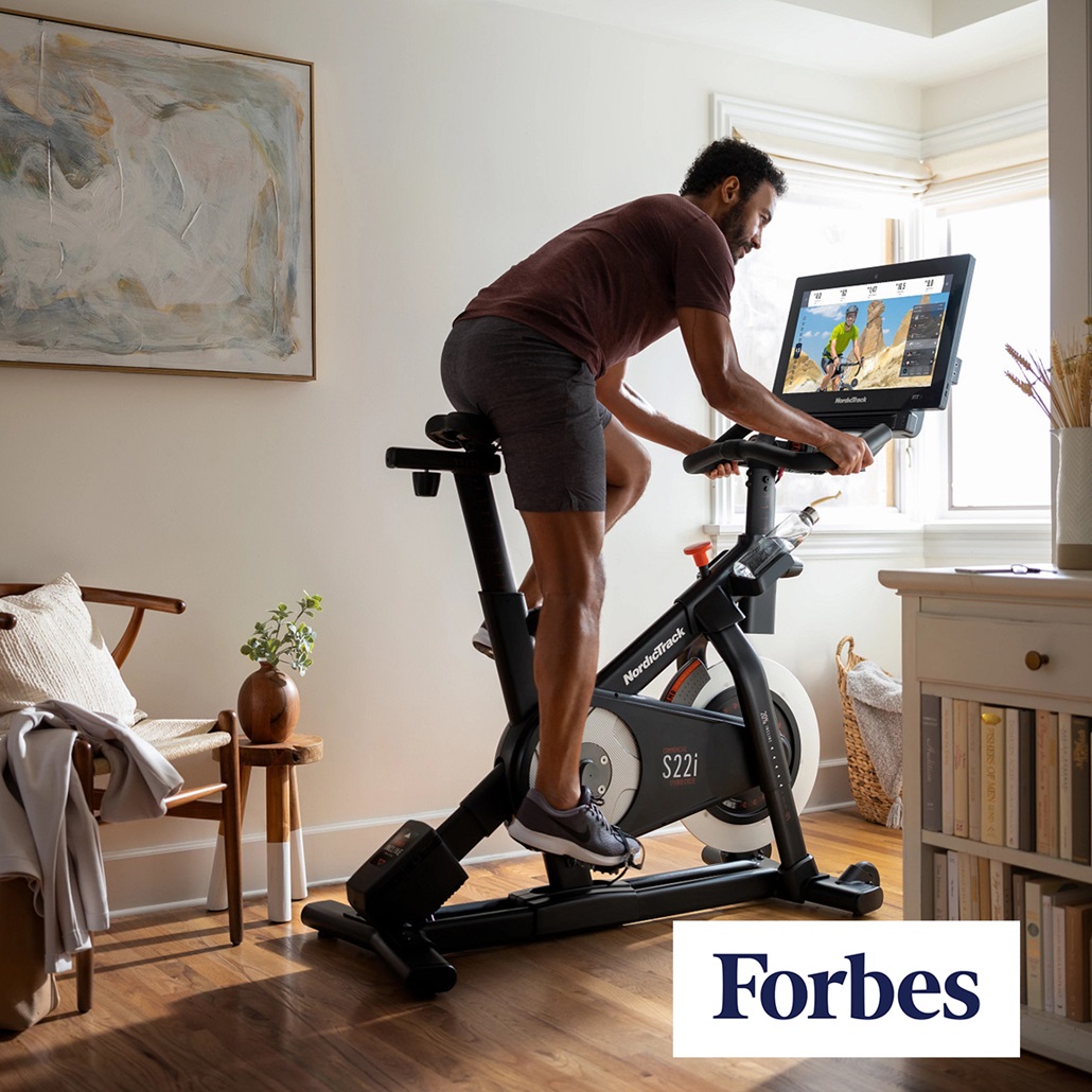 Man on NordicTrack bike - Forbes logo